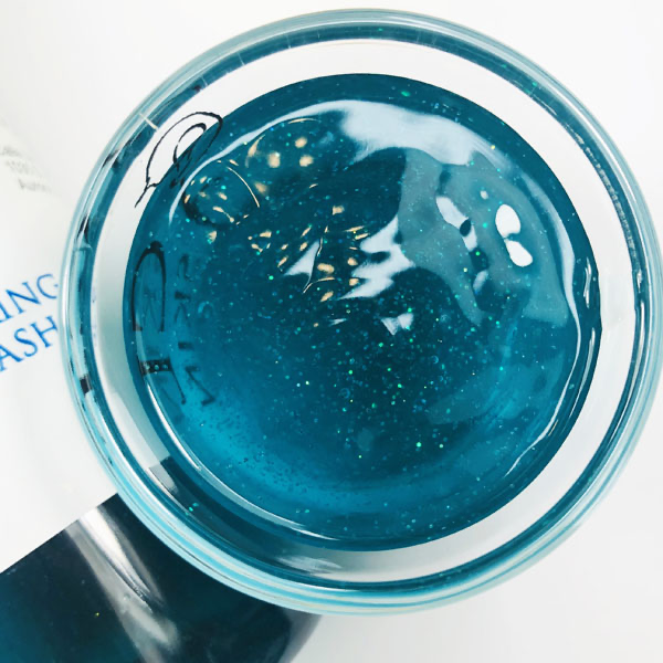 Blue Sheep Shimmering Body Wash in a cup of our blue sheep body wash against a white background