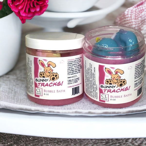 Two jars of Bunny Tracks bubble bath on a surface with a blurred background