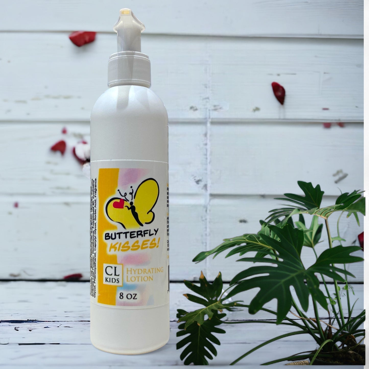 A white pump bottle of our butterfly kisses body lotion against a wood background lotion