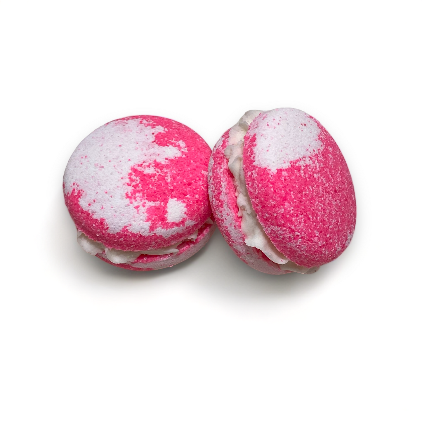 Two pink and white bunny tracks bath cookies against a white background