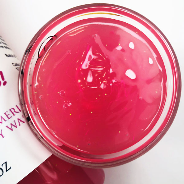 Bunny Tracks Shimmering Body Wash in a cup of our pink body wash against a white background