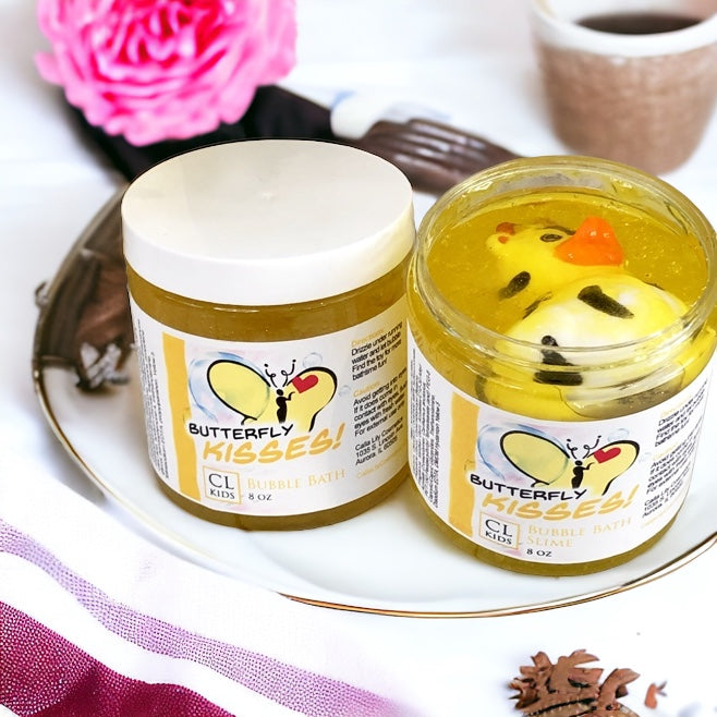 Two jars of 'Butterfly Kisses' bubble bath with a rubber duckie toy on a decorative plate.