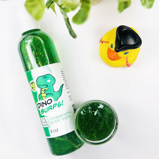 Dino Burps Shimmering Body Wash in a transparent bottle and cup of our green dino burps body wash against a white background