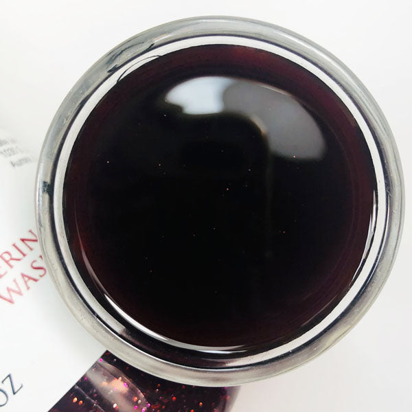 Dragons Blood Shimmering Body Wash in a cup of our dark red dragons blood body wash against a white background