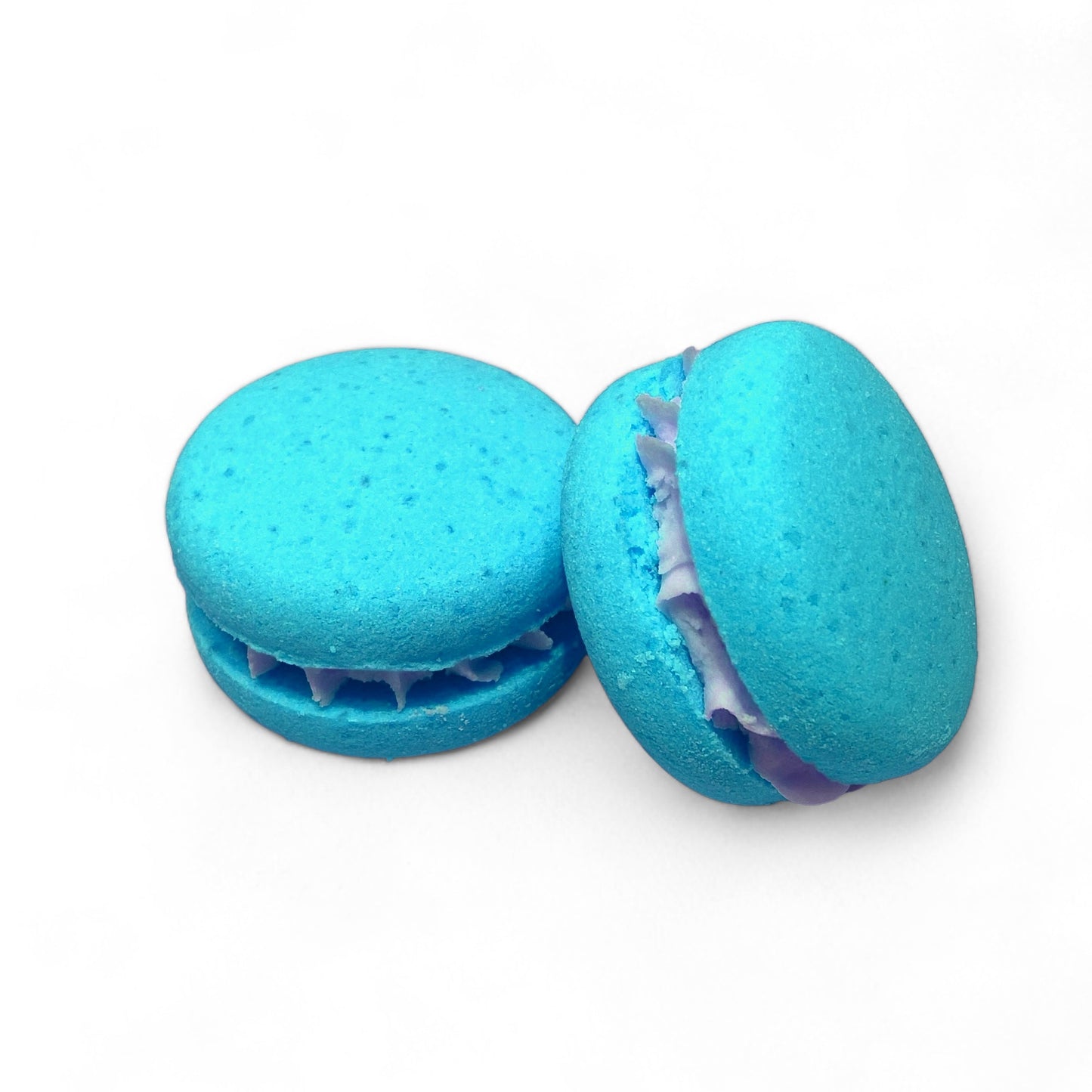 Two teal calla cow bath cookies against a white background