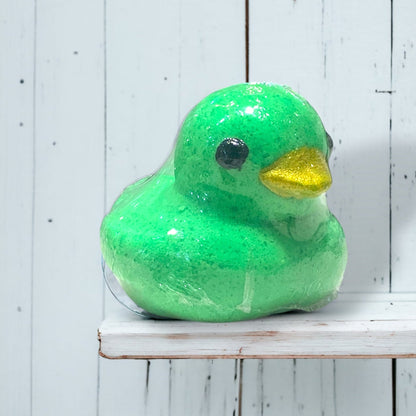 Green rubber duck on a white wooden surface