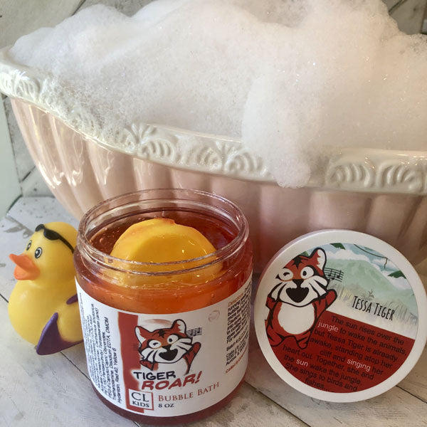 Jar of bubble bath with tiger branding next to a rubber duck and soap dish.