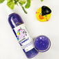 Unicorn Yawns Shimmering Body Wash in a  transparent bottle and cup of our purple unicorn yawns body wash against a white background